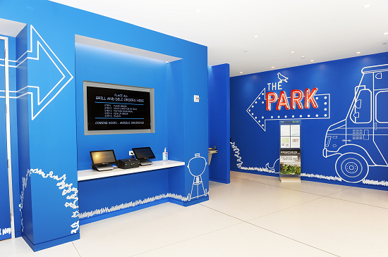 Photo of a room in the Bayer campus with a blue wall that reads, "The Park"